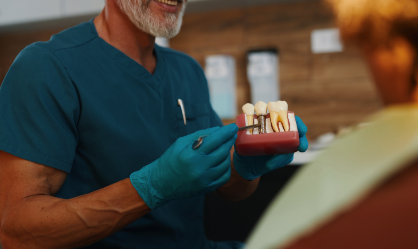 A dentist in Moscow, ID, explaining dental implant treatment for replacing missing tooth and restoring smile